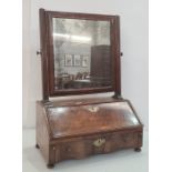 19th century walnut swing toilet mirror, the rectangular plate on fluted supports, the base with