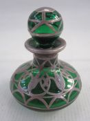 Silver-coloured metal mounted green glass miniature scent bottle having spherical stopper, the squat