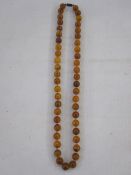 String of amber-type beads and a cameo ring (2)