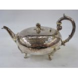 A 19th century silver teapot, with acorn finial, floral engraved, scroll handle, on leaf relief