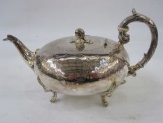 A 19th century silver teapot, with acorn finial, floral engraved, scroll handle, on leaf relief