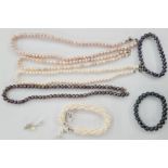 Two pink cultured pearl necklaces, a white pearl necklace, a multi-strand white pearl bracelet