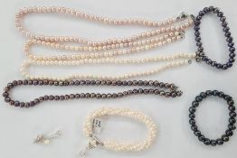 Two pink cultured pearl necklaces, a white pearl necklace, a multi-strand white pearl bracelet