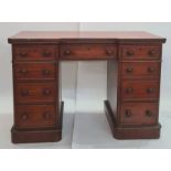 Victorian mahogany kneehole pedestal desk having shaped top with three frieze drawers, an