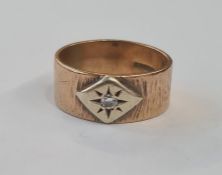 9ct gold and diamond ring, the bark finish band set with single diamond in lozenge surround, 9g