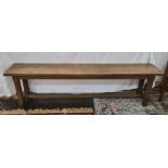Pair of 20th century oak benches on chamfered supports, stretchered bases, 177cm long