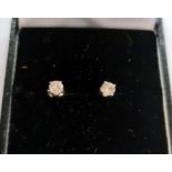 Pair of diamond and silver stud earrings, each stone approximately 0.10ct, claw set