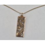 9ct gold pierced pendant, rectangular, scroll decorated on fine 18ct gold chain with engraved