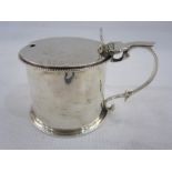 Victorian silver mustard by C Lambert, London 1897, of drum form with beaded rims and scroll handle,