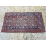 Eastern rug, the red ground field with foliate medallions, with border, 99cm x 174cm