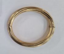 Gold hinged bangle marked 9k of twisted rib design, approx. 25.5g