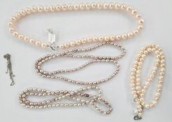 Pink cultured pearl necklace, a pink and white cultured pearl multi necklace and two lilac baroque