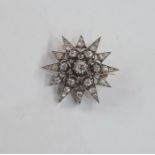 Victorian diamond star-pattern brooch, set with old cut stones in white metal, the central stone