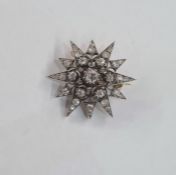 Victorian diamond star-pattern brooch, set with old cut stones in white metal, the central stone