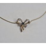 9ct gold diamond sapphire bow pattern necklace, the bow set with small diamonds and single