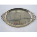 A late 19th/ early 20th century silver two-handled oval tray, beaded rim, scroll shaped handles,