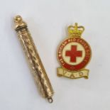 Gold-coloured metal extending propelling pencil and a British Red Cross badge (2)
