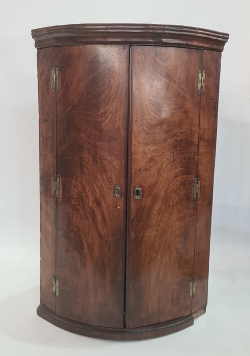 19th century mahogany bowfront two-door wall-hanging cabinet, the cavetto moulded cornice above