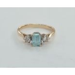 Gold coloured metal, diamond and aquamarine-coloured stone ring set central rectangular blue stone