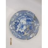 18th century Chinese porcelain charger with scene of skirmish and figures before a pagoda, having