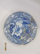 18th century Chinese porcelain charger with scene of skirmish and figures before a pagoda, having