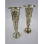 A pair of early 20th century silver weighted trumpet shaped vases, repousse decoration of bows and