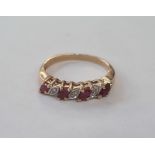 9ct gold, ruby and diamond ring set four elliptical rubies interpersed by three small diamonds