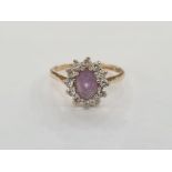 9ct gold, amethyst-coloured stone and white stone dress ring, the oval purple stone surrounded by