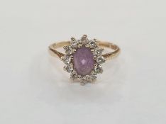 9ct gold, amethyst-coloured stone and white stone dress ring, the oval purple stone surrounded by