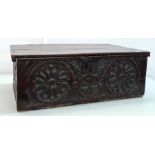 Possibly 16th century oak bible box, the plain rectangular top with carved front featuring two