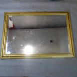 A gilt framed bevelled mirror. H.74 W.104cm