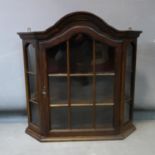 A 20th century Dutch walnut display cabinet, with moulded cornice above astragal glazed door, H.68