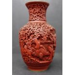 A Chinese cinnabar lacquer vase, decorated in relief with vignettes of figures in landscapes