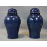 A pair of Chinese blue glazed temple jars and covers, with character marks to base, H.53cm
