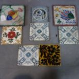 A collection of eight tiles, two include two large tiles decorated with fish, 20 x 20cm, a Minton'