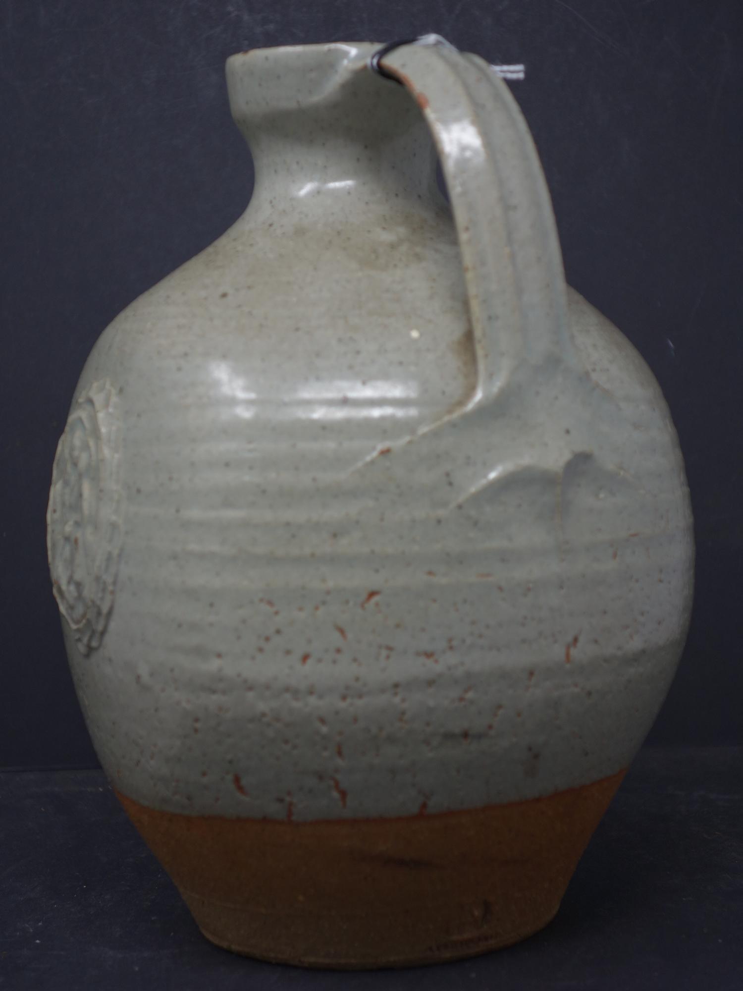 A holy water jug in stoneware with a light green glaze and decorative cartouche of virgin and - Image 4 of 4