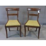 A pair of Regency mahogany dining chairs, with hessian drop in seats, on sabre legs