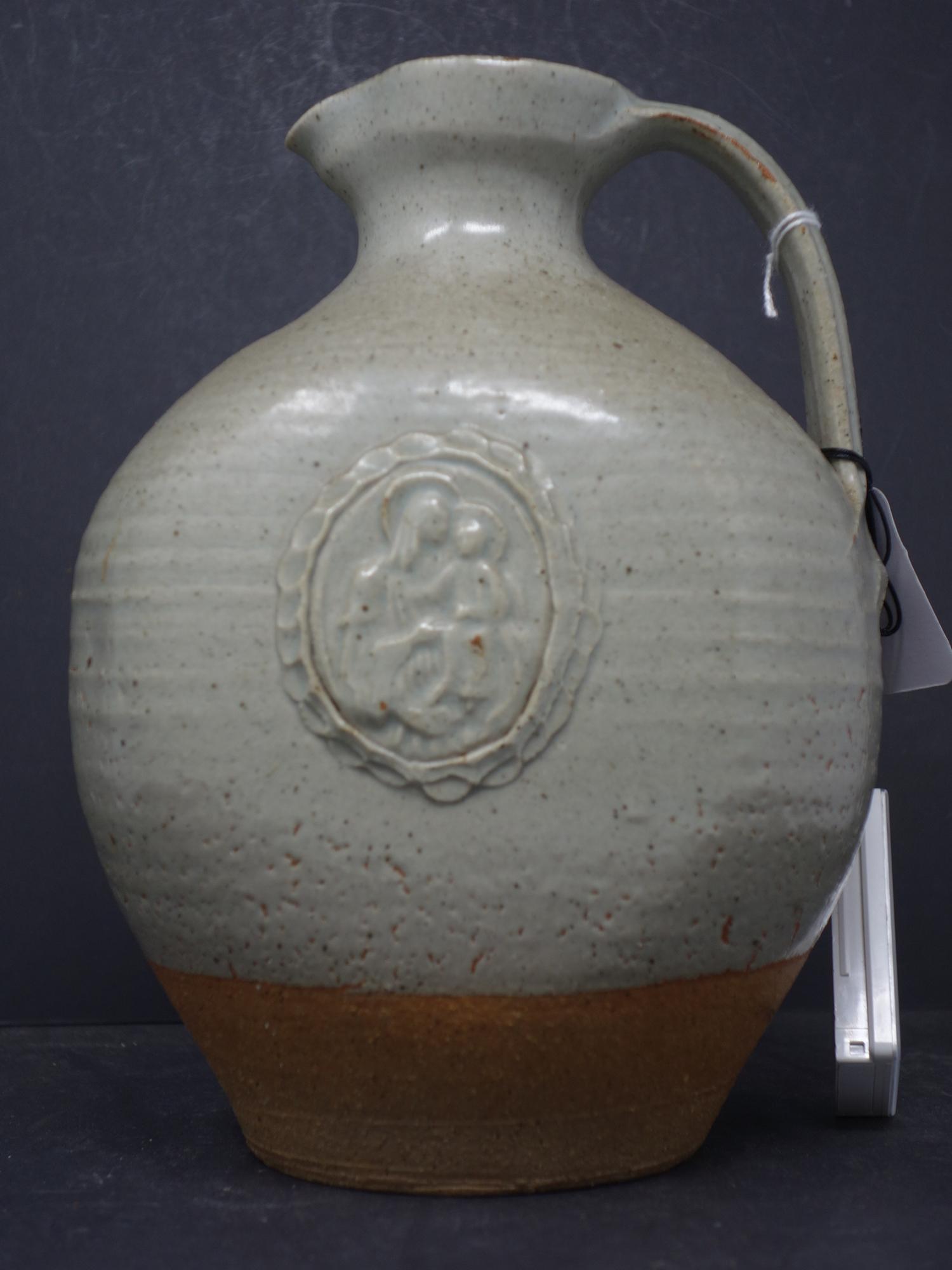 A holy water jug in stoneware with a light green glaze and decorative cartouche of virgin and - Image 2 of 4