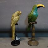 A moulded toucan on stand, H.42cm, together with a moulded parrot on a stand, H.36cm