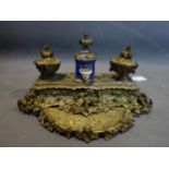 A 19th century French ormolu ink desk stand, with central porcelain pot and applied animals, H.20