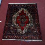 A north west Persian Senneh rug, the central diamond medallion with repeating petal motifs, on a