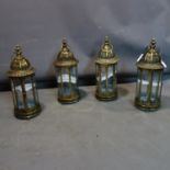 A set of four contemporary gilt metal storm lanterns with domed tops, H.55cm