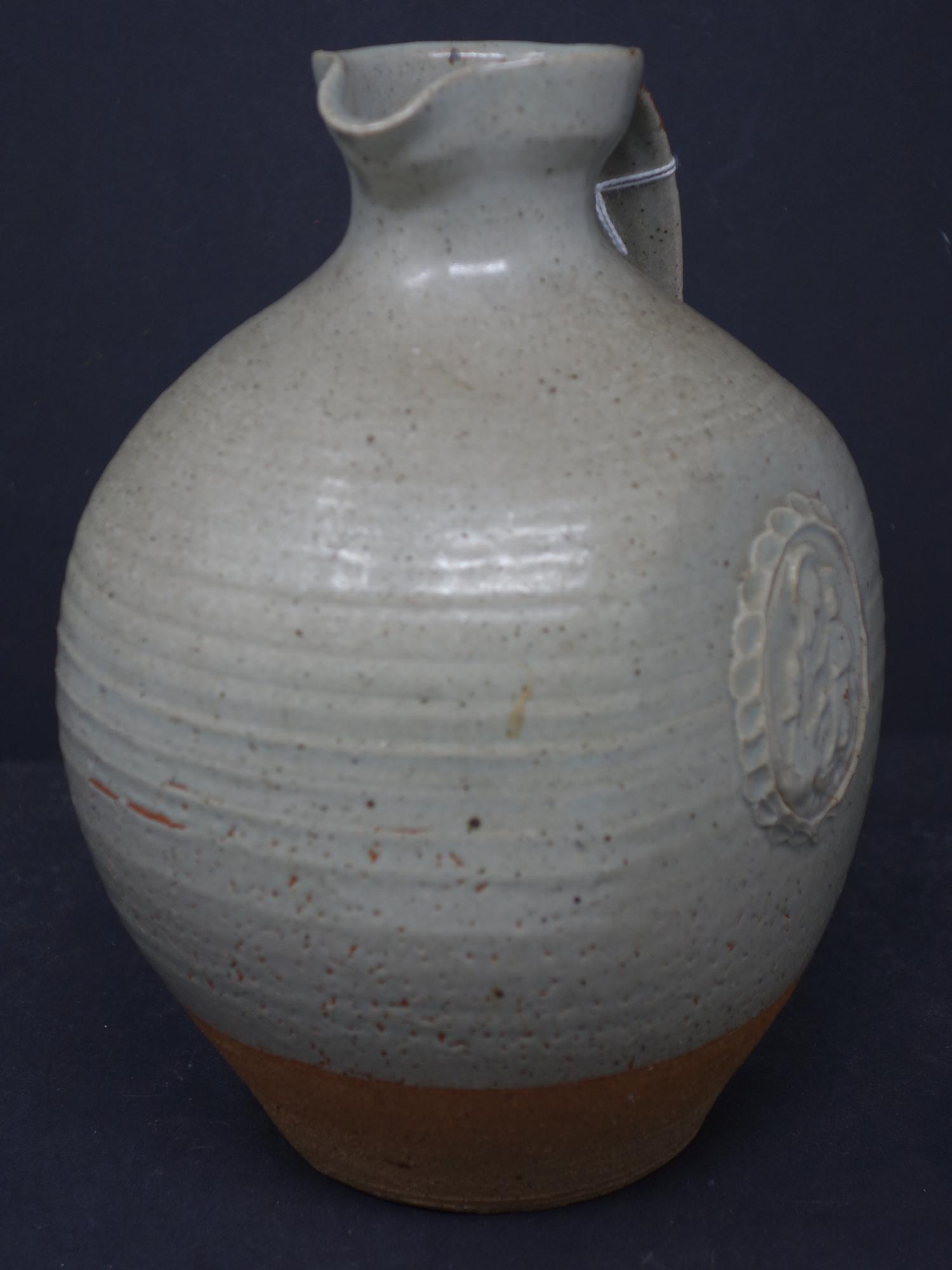 A holy water jug in stoneware with a light green glaze and decorative cartouche of virgin and - Image 3 of 4