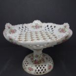 A 19th century continental porcelain tazza, with pierced lattice design and hand painted floral