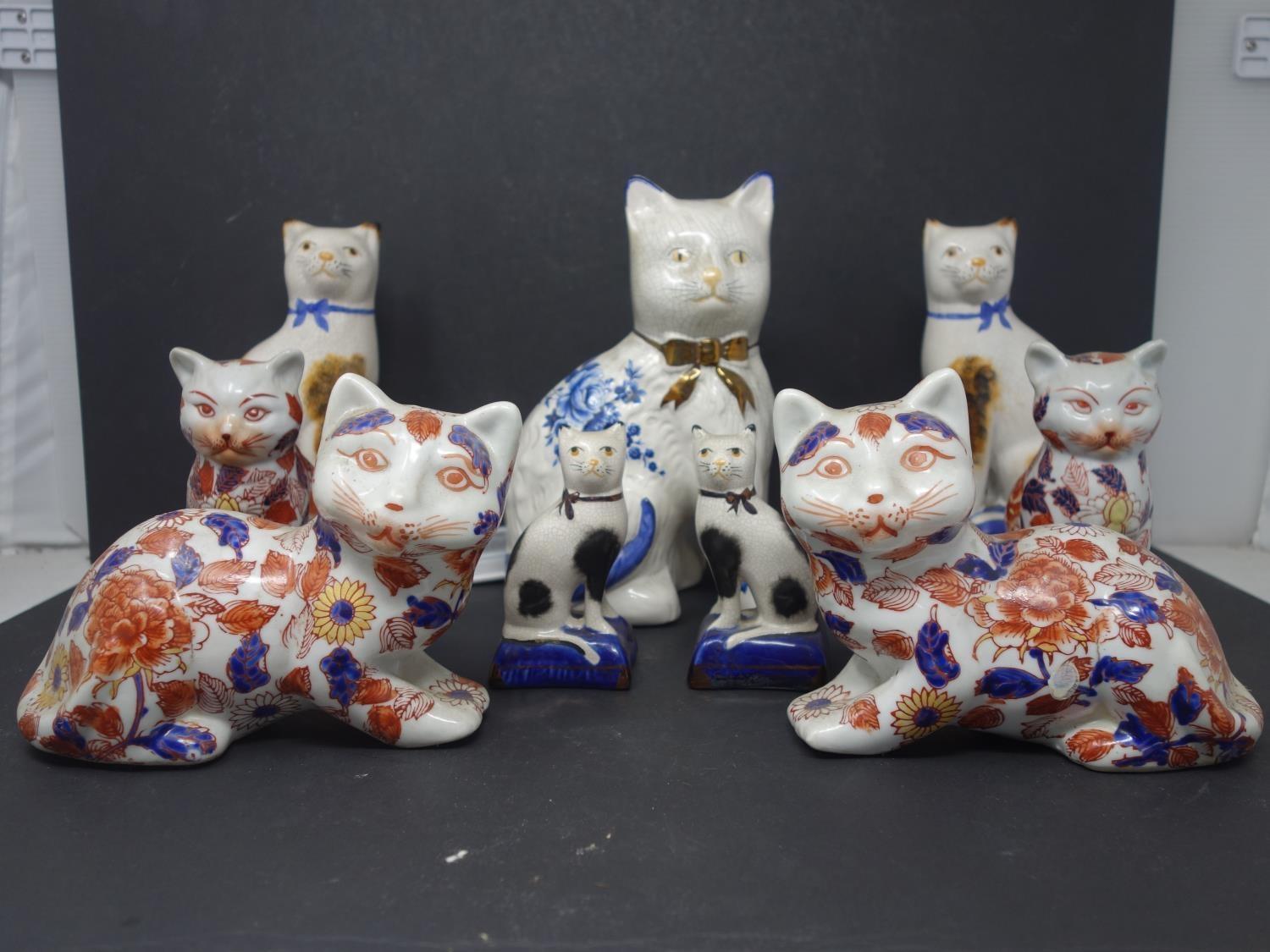 Two pairs of early 20th century Chinese ceramic cats, with character marks to base, together with