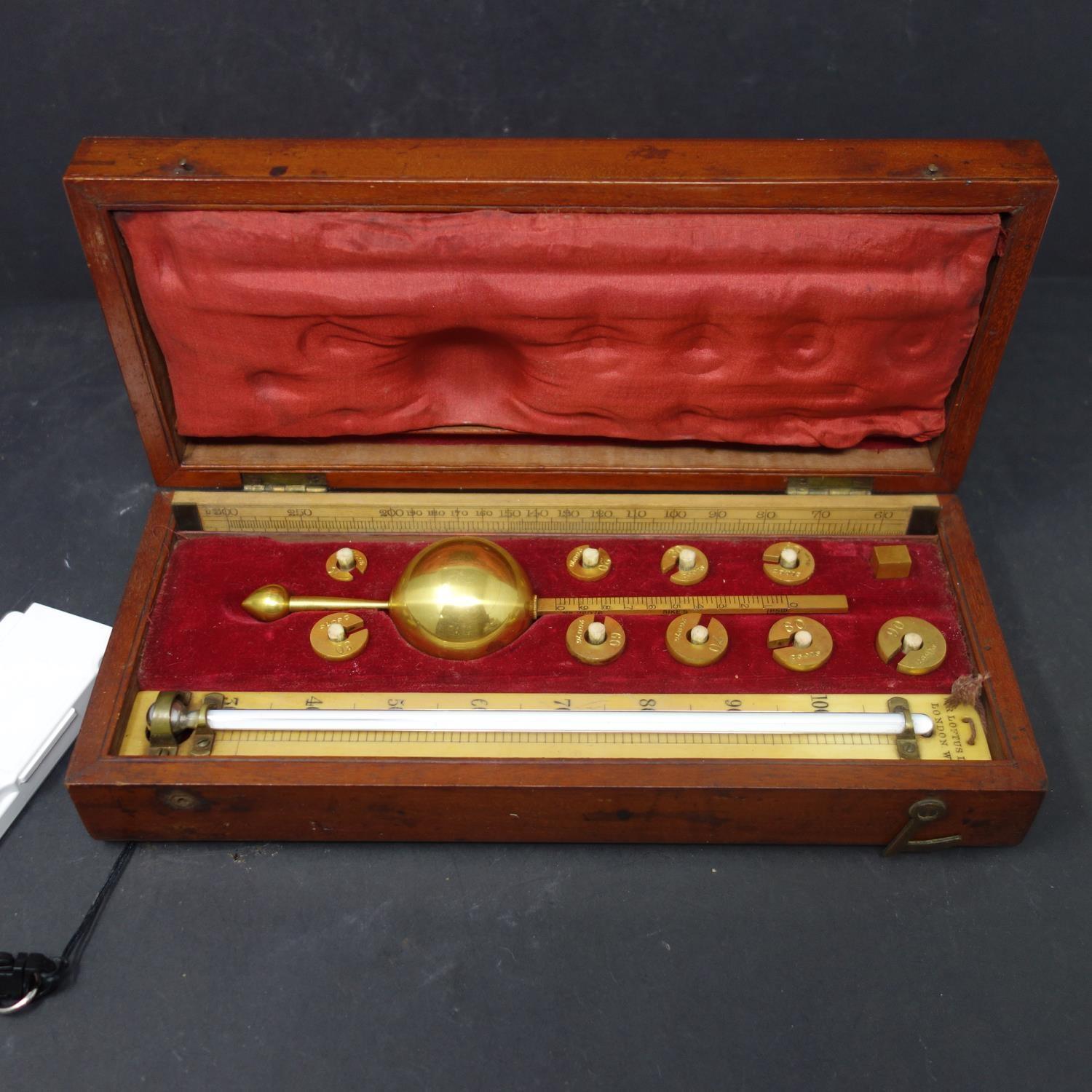 A cased Sikes' hydrometer, with brass weights, and thermometer marked 'W.R. Loftus, London W.', W.25 - Image 2 of 2