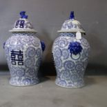 A pair of contemporary Chinese temple jars and covers, with Dog of Fo finials, decorated with