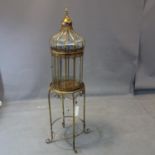 A contemporary gilt storm lantern on stand, H.136cm (total), lantern is missing 2 glass panels