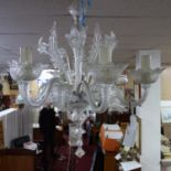A Murano six branch glass chandelier, with daffodils and leaves, H.76cm Diameter 68cm
