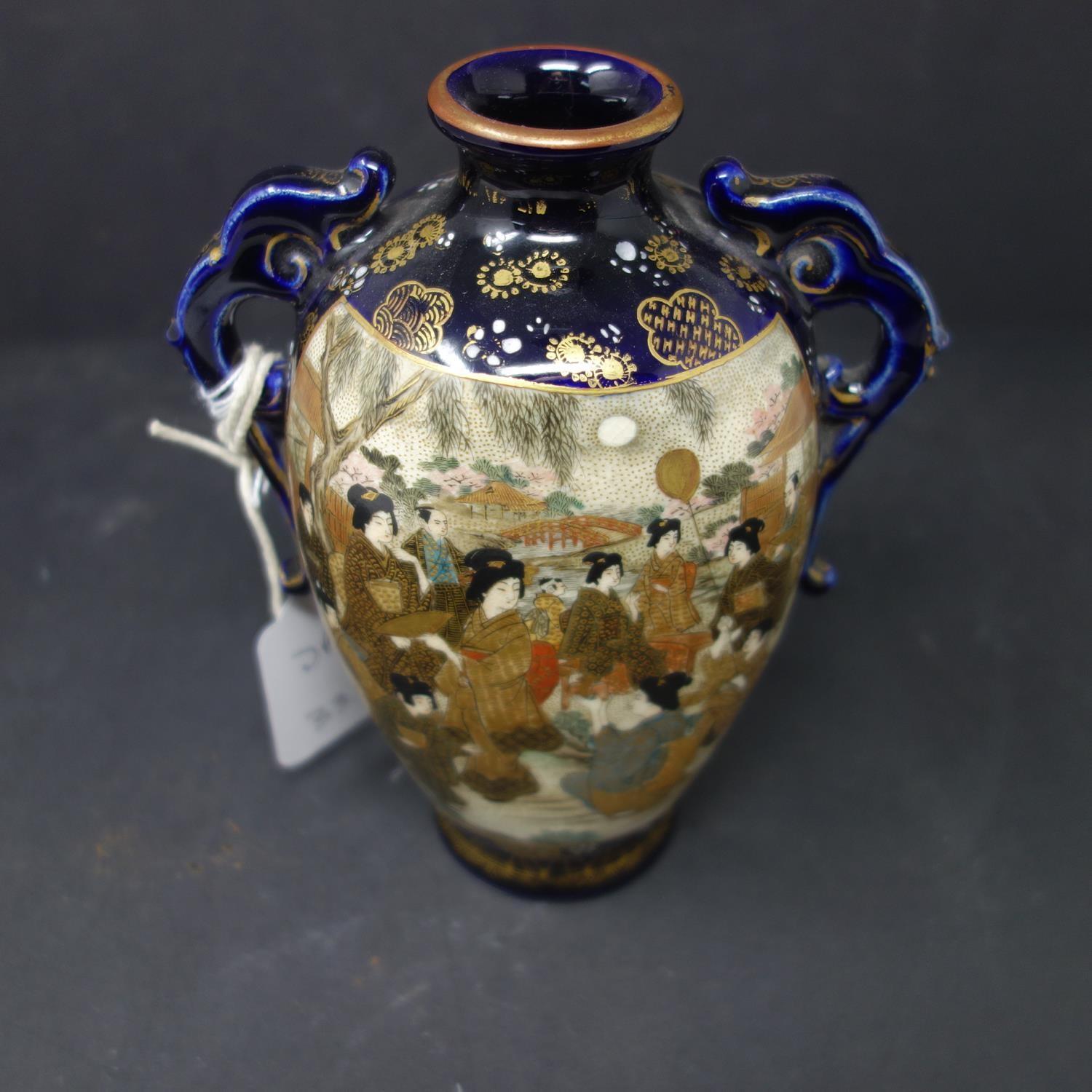 A Japanese twin handle satsuma vase, decorated with vignettes of geishas and warriors, stamped to - Image 2 of 3